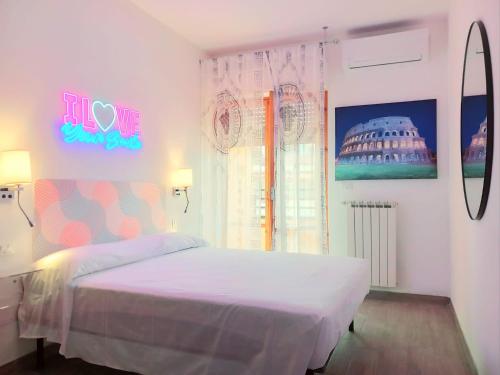 a bedroom with a bed with a sign on the wall at Casa Vacanze MARE BOOM in Martinsicuro