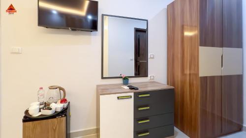 a bathroom with a sink and a mirror and a cabinet at Pyramids Tower view inn in Nazlat as Sammān