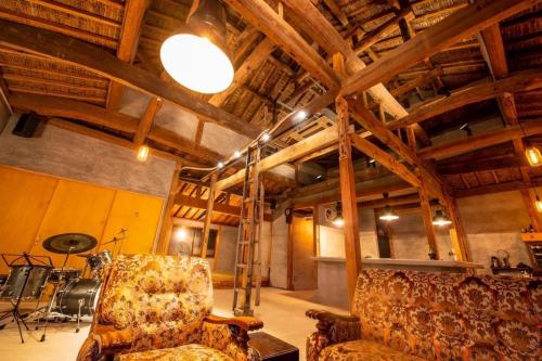 a room with two chairs in a room with wooden ceilings at Awajishima dog stay, CHIKUSA - Vacation STAY 17225v in Sumoto