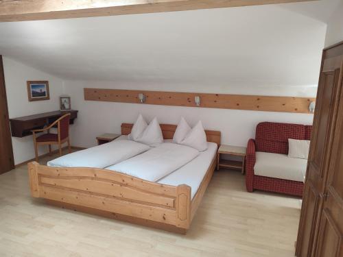 1 dormitorio con cama de madera y piano en Haus Enzian, en Mittersill