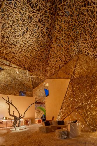 a room with a stone wall and a ceiling at Hotel Villas Flamingos in Holbox Island