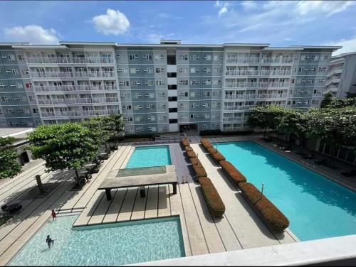 a large apartment building with two large swimming pools at La studio tropical manila in Manila