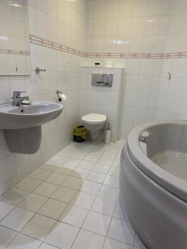 a white bathroom with a sink and a toilet at Anielski Zakątek Polańczyk in Polańczyk
