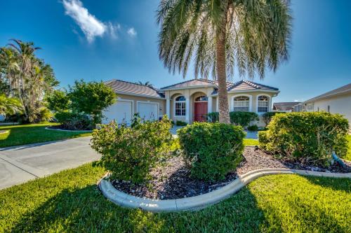 a palm tree in front of a house at Villa-Haze, lots of privacy, solar & electric heated pool and SPA in Cape Coral