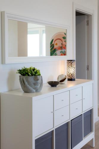 a white cabinet with a plant on top of it at HOGAR DEL MAR in Oia