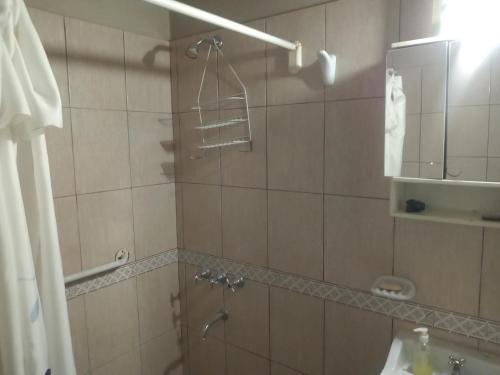 a bathroom with a shower and a sink at Casita de mis viejos in Mendoza