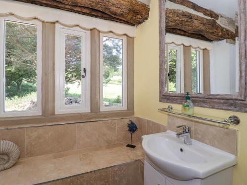 a bathroom with a sink and four windows at Cunliffe House in Shipley