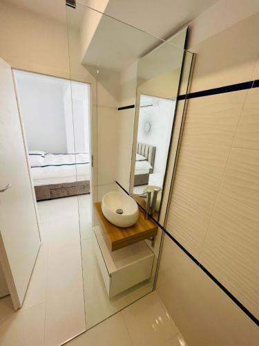 a bathroom with a toilet and a mirror at Oxygen Residence D3 in Neptun