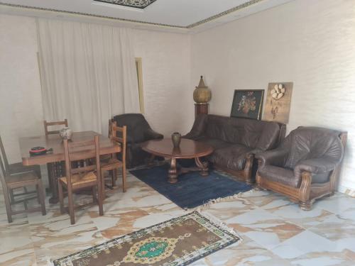 a living room with a couch and a table at Villa ahlam in Essaouira