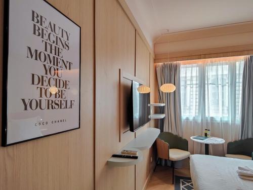 a hotel room with a bedroom with a bed and a tv at Aparthotel AMMI Nice Lafayette in Nice
