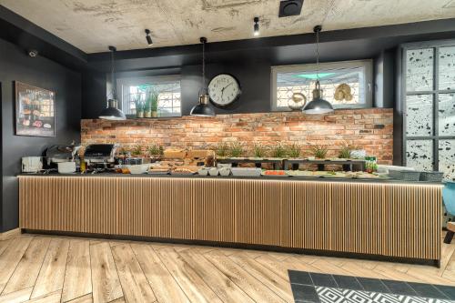 a counter in a restaurant with a brick wall at Stawa Villa & Apart in Świnoujście