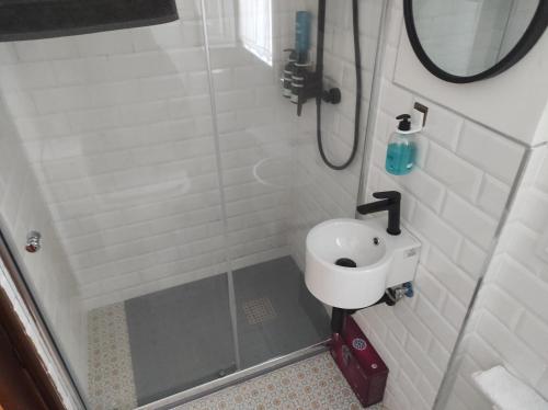 a small bathroom with a sink and a shower at EL CAPRICHO DE BACO in Haro