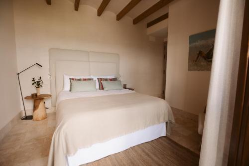 a bedroom with a large white bed in a room at Casa Aura Hotel in Vejer de la Frontera