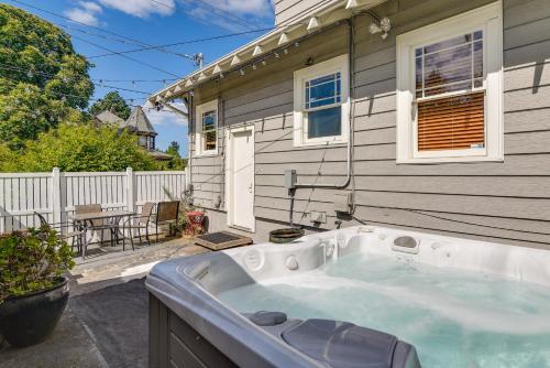 a bath tub sitting outside of a house at Walk to Williams District Home with Hot Tub and Patio in Portland