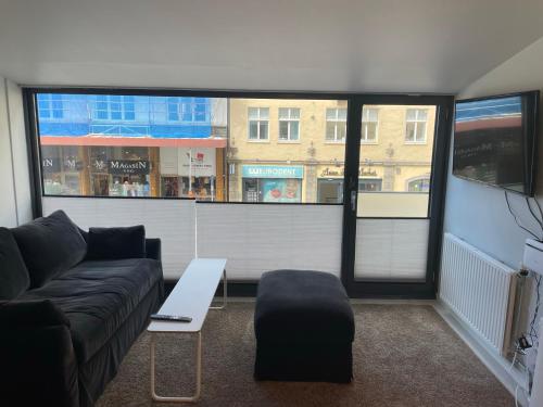 a living room with a couch and a table at Cozy apartment in the middle of Bergen city center in Bergen