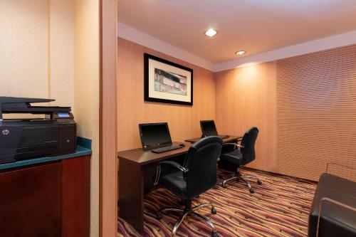a hotel room with two desks and two computers at Holiday Inn - Suites Kuwait Salmiya by IHG in Kuwait