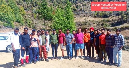 a group of men posing for a picture in front of a mountain at Veda Inn in Chakrāta