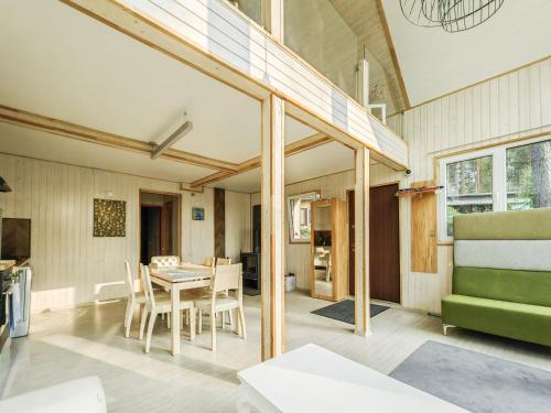 a kitchen and dining room with a table and chairs at River bank vacation home in Jūrmala