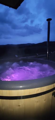 bañera púrpura con cielo púrpura en Góralskie Domki na Podhalu - z jacuzzi en Maniowy