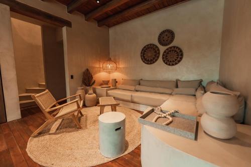 a living room with a couch and a table at Makani Luxury Wanderlust in Tierra Bomba