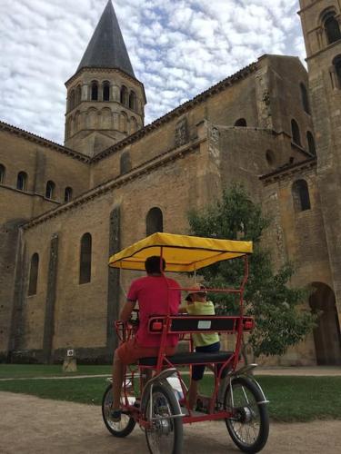 a man riding a red bike with a yellow umbrella at A la Redoute in Hautefond