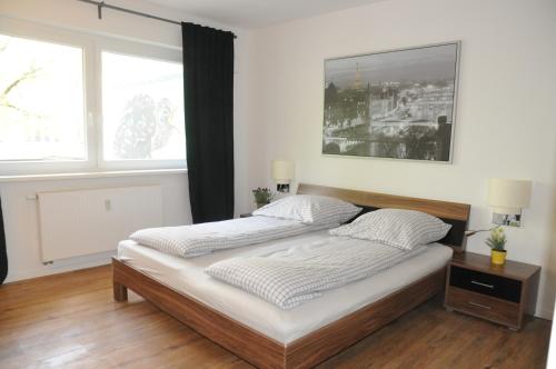 a bedroom with a bed and a large window at Apartment Schmidt in Berlin