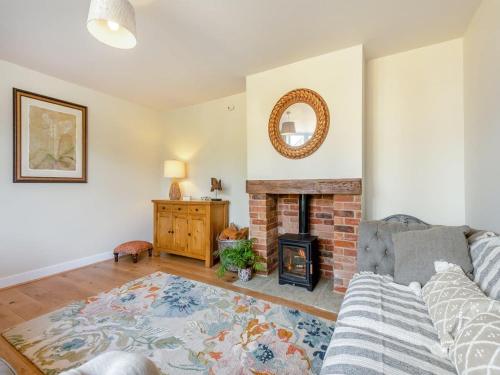 a living room with a couch and a fireplace at Avondale New Forest in Godshill