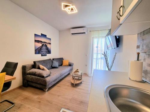 a living room with a couch and a sink in it at Julia in Biograd na Moru
