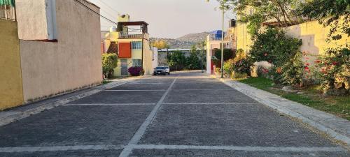 an empty street with a car driving down the road at Casa El Amate in Emiliano Zapata
