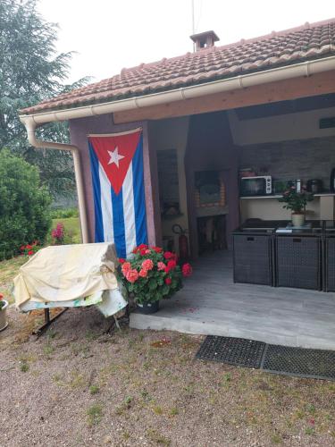 a flag is hanging on the front of a house at L'hacienda de Maria montchanin in Montchanin