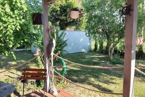 a statue of a bird standing in a yard at Holiday Home in Nowe Warpno by the Harbor in Nowe Warpno