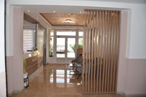 a hallway with a wooden partition in a room at Guest House Zec in Budva