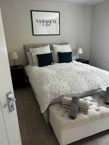 a bedroom with a large bed and a couch at Entire Modern Apartment in Oban with Balcony in Oban