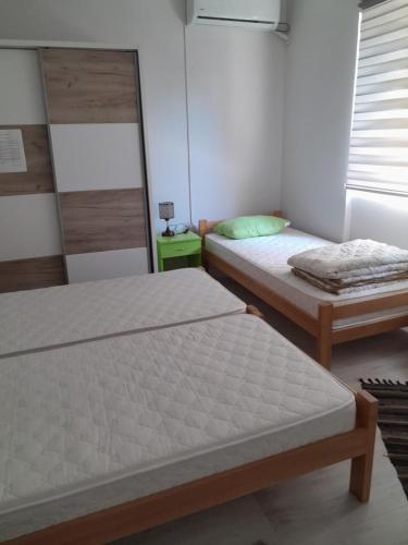 a bedroom with two beds and a window at Lipov lad in Bela Crkva