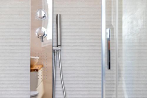 a shower with a glass door in a bathroom at Sea inside luxury apartment: vista mozzafiato in Alghero