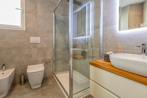 a bathroom with a shower and a sink and a toilet at Sea inside luxury apartment: vista mozzafiato in Alghero
