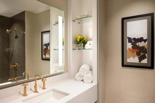 a bathroom with a sink and a mirror at The MC, Autograph Collection in Montclair