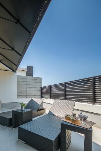 a patio with a table and chairs on a roof at Sakura Terrace The Gallery in Kyoto