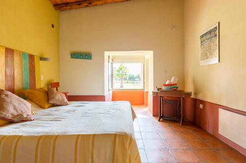 a bedroom with a large bed and a window at Avalenn, Casa de Campo in Tunuyán