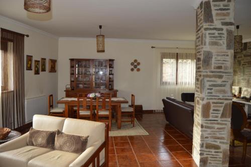 a living room with a couch and a table at Maria's Country House in Miranda do Douro
