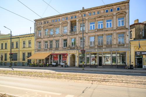 an empty street in front of a large building at Teatrum in Liepāja