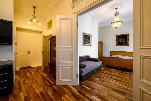 a living room with a couch and a bedroom at Teatrum in Liepāja