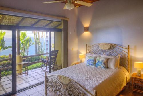 a bedroom with a bed and a balcony at Villa for 12 Guests with private pool and SPECTACULAR Ocean View in Uvita