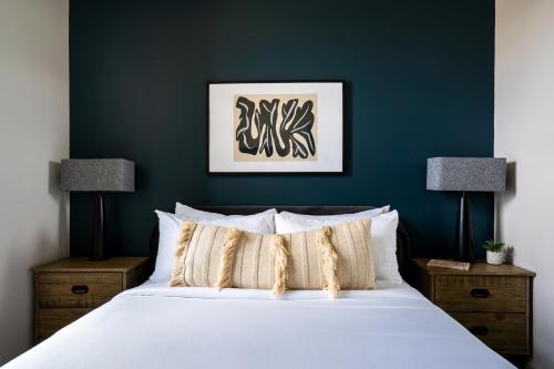 a bedroom with a large white bed and two lamps at Kasa Archive Reno-Tahoe in Reno