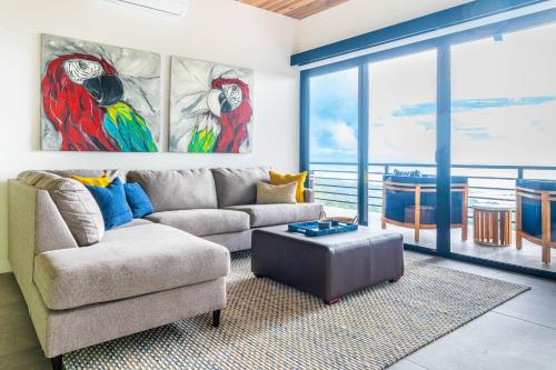 a living room with a couch and a table at Casa Amigos - By Pura Villas in Dominical
