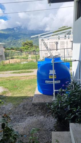 a large blue barrel sitting on the side of a house at Vistaverdeboquete in Boquete