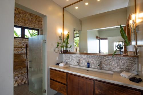 a bathroom with a sink and a mirror at Luxe 4 Bdrm Villa with Epic OceanView & Infinity Pool in Dominicalito