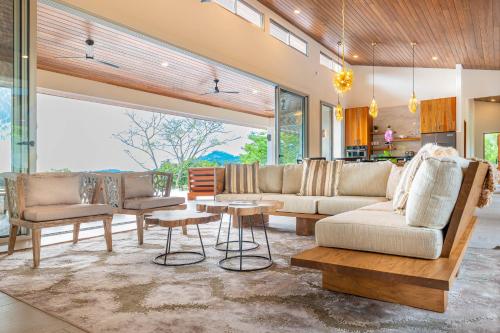 a living room with two couches and a table at Casa Grande del Mar - by Pura Villas in Punta Mala