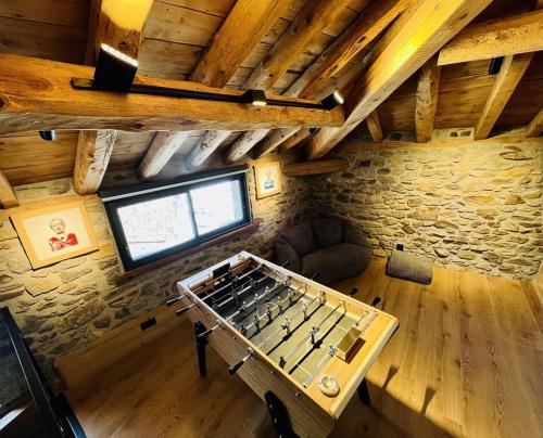 an overhead view of a room with a foosball table at Le Refuge Cal Chalon , chalet de luxe au cœur du village in Les Angles