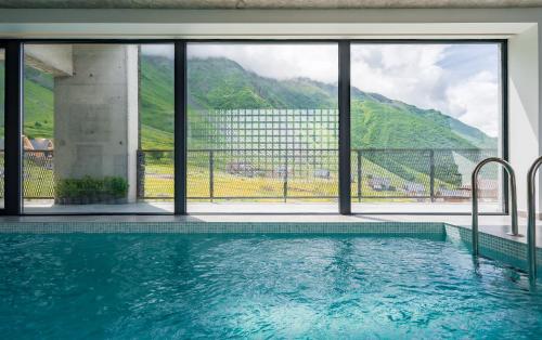 a swimming pool with a view of a mountain at Step Inn - Kazbegi in Stepantsminda